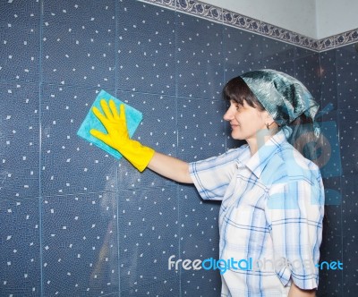 Woman Washes A Tile In The Bathroom Stock Photo