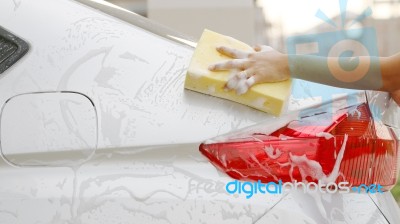 Woman Washing A Car With A Sponge And Soap Stock Photo