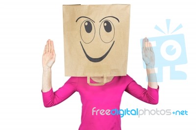 Woman Wearing Paper Bag With Happy Facial Expression On Head Stock Photo