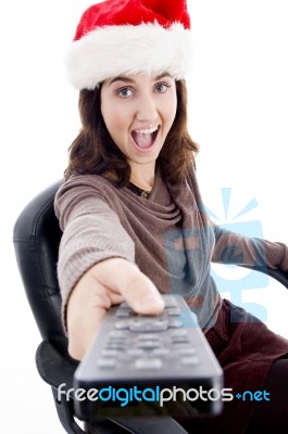 Woman Wearing Santa Hat With Remote Stock Photo