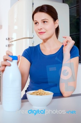 Woman With Cereal And Milk Stock Photo