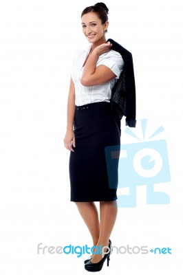 Woman With Coat Slung Over Her Shoulder Stock Photo