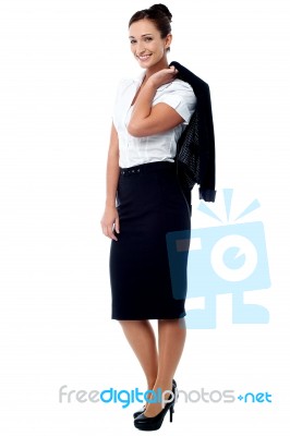 Woman With Coat Slung Over Her Shoulder Stock Photo