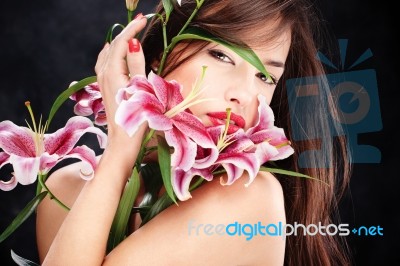 Woman With Oriental Flowers Stock Photo