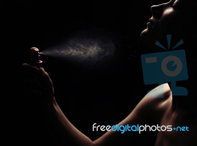 Woman With Perfume On Black Background Stock Photo
