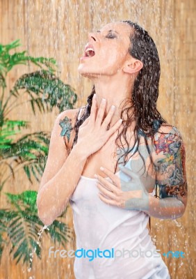 Woman With Tattoos Under Shower Stock Photo
