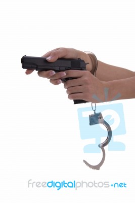 Woman's Hand With Handcuffs And Gun On A White Background Stock Photo