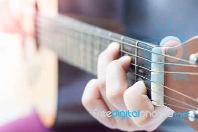 Woman's Hands Playing Acoustic Guitar Stock Photo