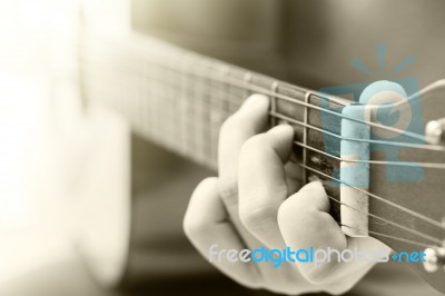 Woman's Hands Playing Acoustic Guitar With Vintage Filter Stock Photo