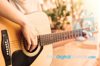 Woman's Hands Playing Acoustic Guitar With Vintage Style Stock Photo