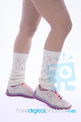 Woman's Legs With Leg Warmer And Tennis Shoes Stock Photo