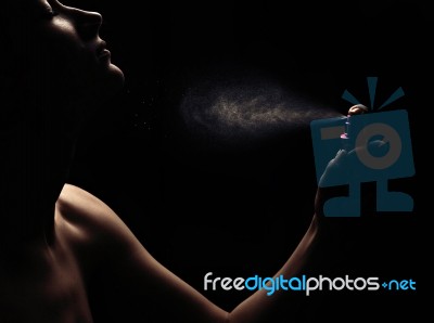 Woman's Perfume In The Hand On Black Background Stock Photo