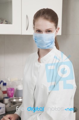 Women Doctor With Face Mask In The Office Stock Photo