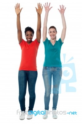 Women Raising Their Arms Up In Excitement Stock Photo