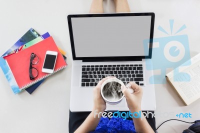 Women Sitting And Handtake Cup Of Hot Coffee Watching Media Stock Photo