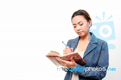 Women Write In A Book Stock Photo