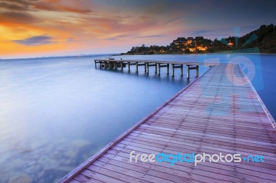 Wood Bridge Piers With Nobody And Smoothy Sea Water Against Beau… Stock Photo