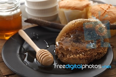 Wood Honey Dipper With Soft Cake Still Life Closeup Stock Photo