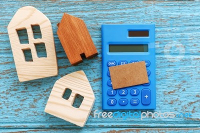 Wood House And Calculator Stock Photo