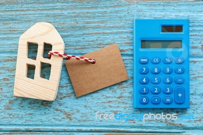 Wood House With Calculator And Blank Label Stock Photo