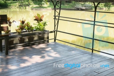 Wooden Bench In A Water House Garden Stock Photo