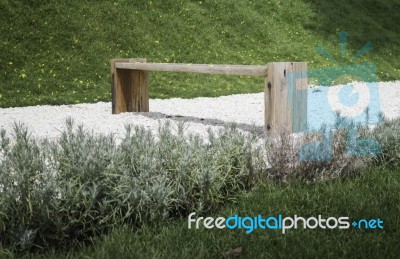 Wooden Bench In Rock Garden Stock Photo