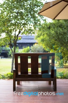 Wooden Chair In The Green Garden Stock Photo