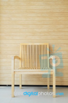 Wooden Chair With Wooden Wall In Background Stock Photo