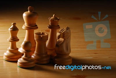 Wooden Chess Pieces On Wooden Table Stock Photo