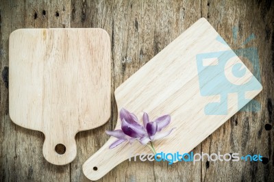 Wooden Chopping Board On Old Wooden Table. Top View Stock Photo