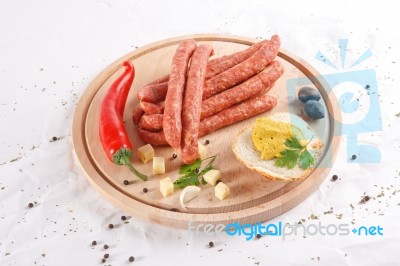 Wooden Chopping Board With Sausages, Cheese, Bread Stock Photo