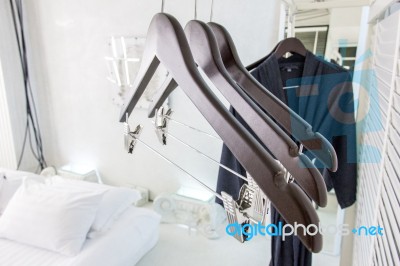Wooden Cloth Hangers On Clothes Rail And Bathrobe Stock Photo