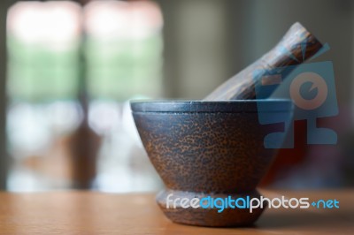 Wooden Mortar And Pestle On A Wooden Desk And Living Room Background Stock Photo