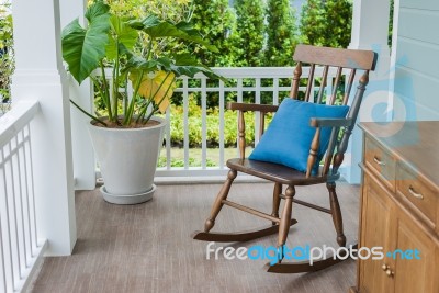 Wooden Rocking Chair On Front Porch Stock Photo