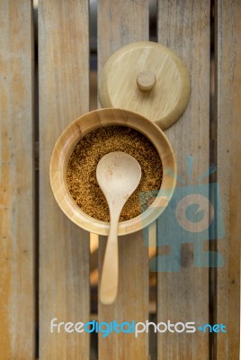 Wooden Spoon In Brown Sugar Bowl On Wood Table Stock Photo
