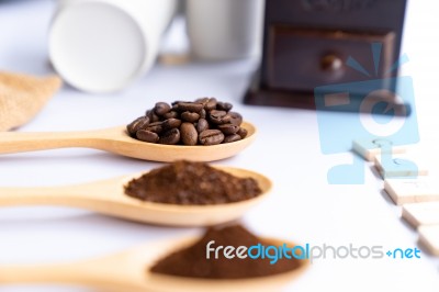 Wooden Spoons Filled With Coffee Bean And Crushed Ground Coffee Stock Photo