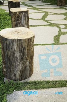 Wooden Stool On Green Garden Stock Photo