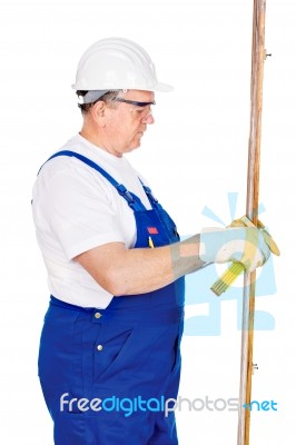 Worker Measuring The Board Stock Photo