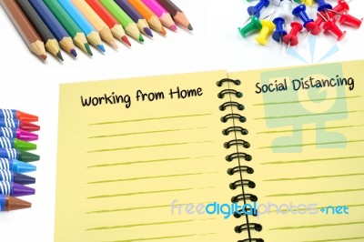 Working From Home And Social Distancing Texts On Notebook Stock Photo