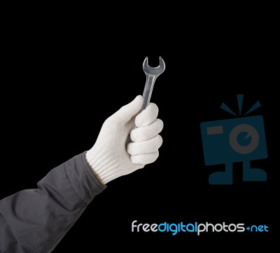 Working Hand In Glove Holding Wrench Stock Photo