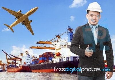Working Man And Commercial Ship On Port And Air Cargo Plane Flyi… Stock Photo