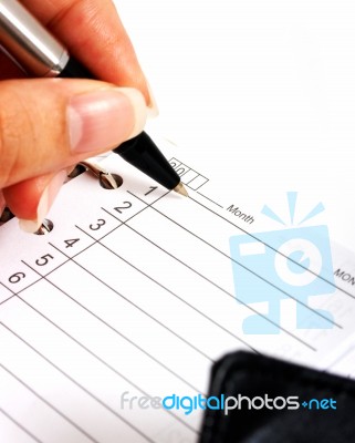 Writing In Daily Planner Organizer Stock Photo