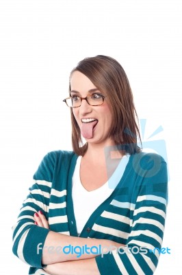 Wwoman Posing With Tongue Out And Arms Crossed Stock Photo