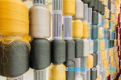 Yellow And Gray Silk Thread In Spool Stock Photo