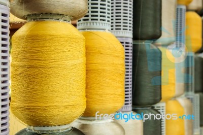 Yellow And Gray Silk Thread In Spool Stock Photo