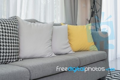 Yellow And Grey Pillows On Modern Sofa Stock Photo