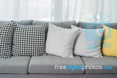 Yellow And Grey Pillows On Modern Sofa Stock Photo