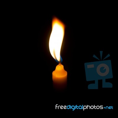 Yellow Candle lit Stock Photo