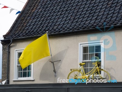 Yellow Flag And Bicycle On A House In Southwold Stock Photo