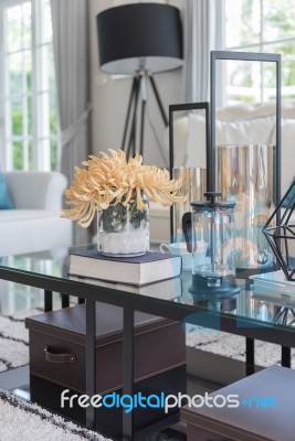 Yellow Flower In Glass Vase And Book  On Glass Table In Living R… Stock Photo